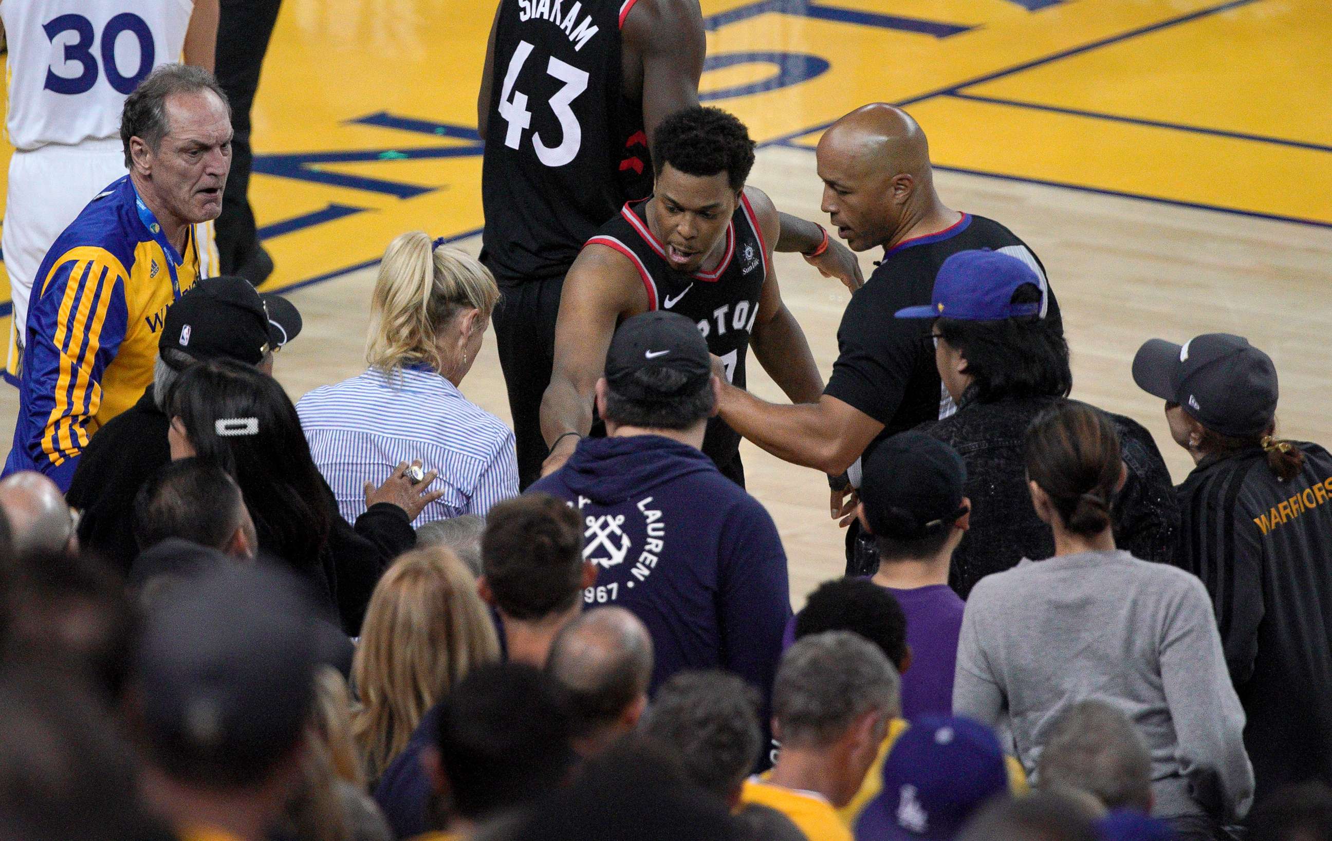 PHOTO: Toronto Raptors guard Kyle Lowry (7) gestures next to referees Marc Davis near the front row of fans during the NBA Finals between the Golden State Warriors and the Raptors in Oakland, Calif., June 5, 2019.