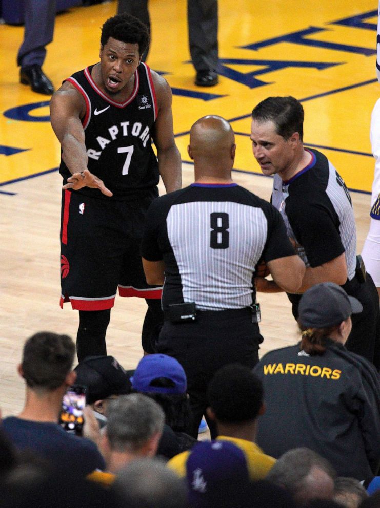 PHOTO: Toronto Raptors guard Kyle Lowry (7) gestures next to referees Marc Davis and Kane Fitzgerald near the front row of fans during the NBA Finals between the Golden State Warriors and the Raptors in Oakland, Calif., June 5, 2019.