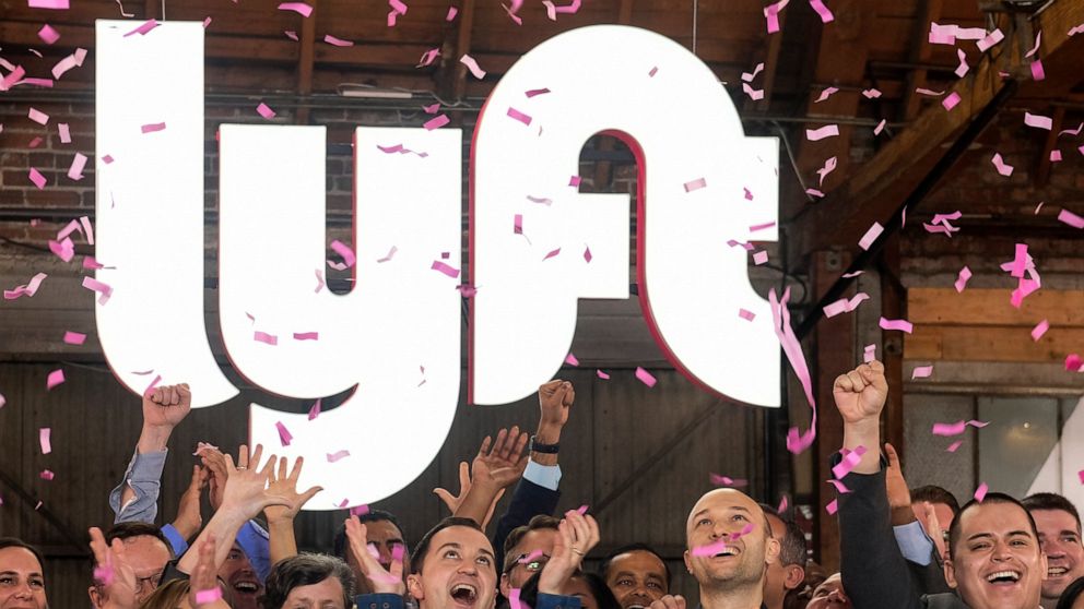 PHOTO: In this Friday, March 29, 2019 file photo, Lyft co-founders John Zimmer, front second from left, and Logan Green, front second from right, cheer as they as they ring a ceremonial opening bell in Los Angeles, to mark trading on the Nasdaq exchange.