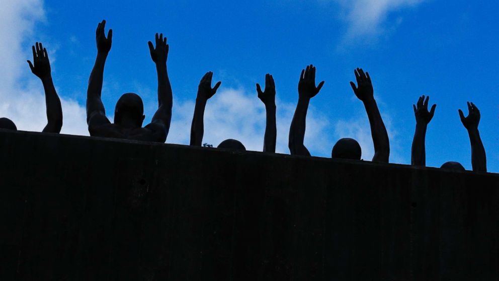 A bronze statue entitled "Raise Up", is included at the National Memorial for Peace and Justice, a new memorial to honor thousands of people killed in lynchings, April 23, 2018, in Montgomery, Ala.