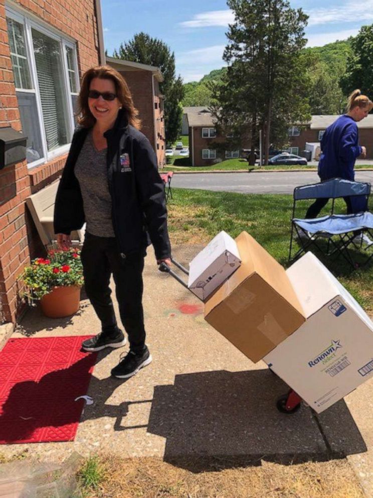 PHOTO: Neighbors help move donated furnishings into Lynn Schutzman's new apartment. Neighbors responded to a Nextdoor app request asking to help Schutzman get on her feet in April.