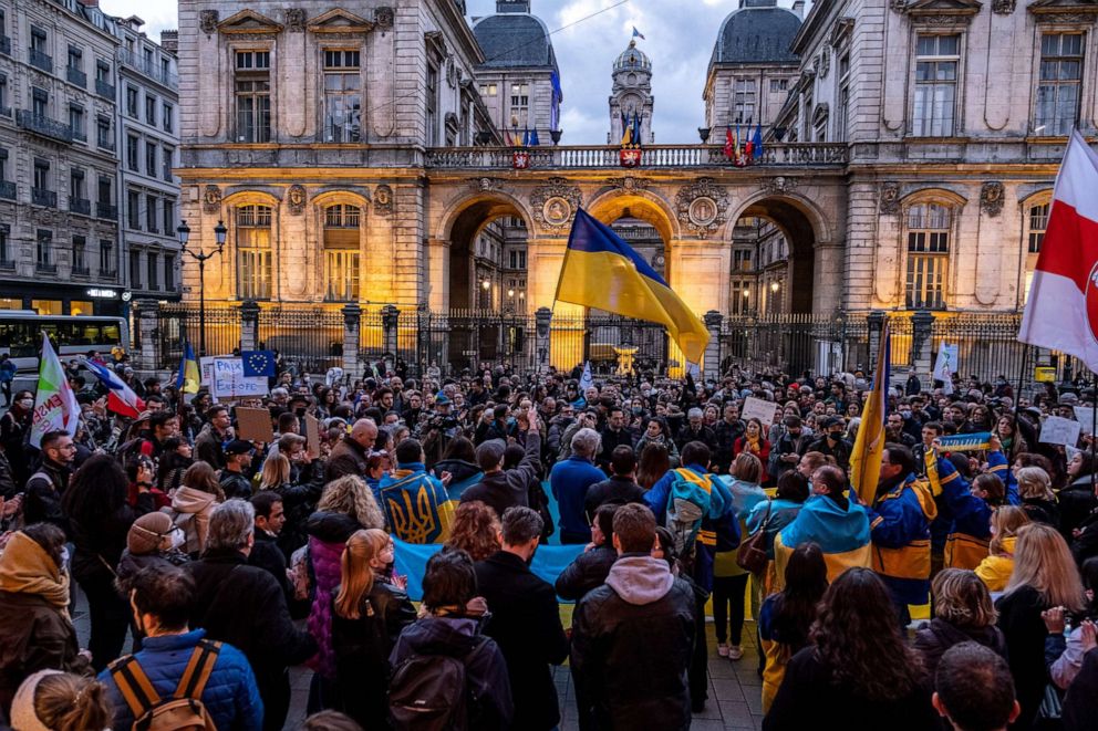 PHOTO: People gather in front of the city hall in support of the Ukrainian people and to protest the invasion of Ukraine by Russia military operation, on Feb. 24, 2022, in Lyon, France.