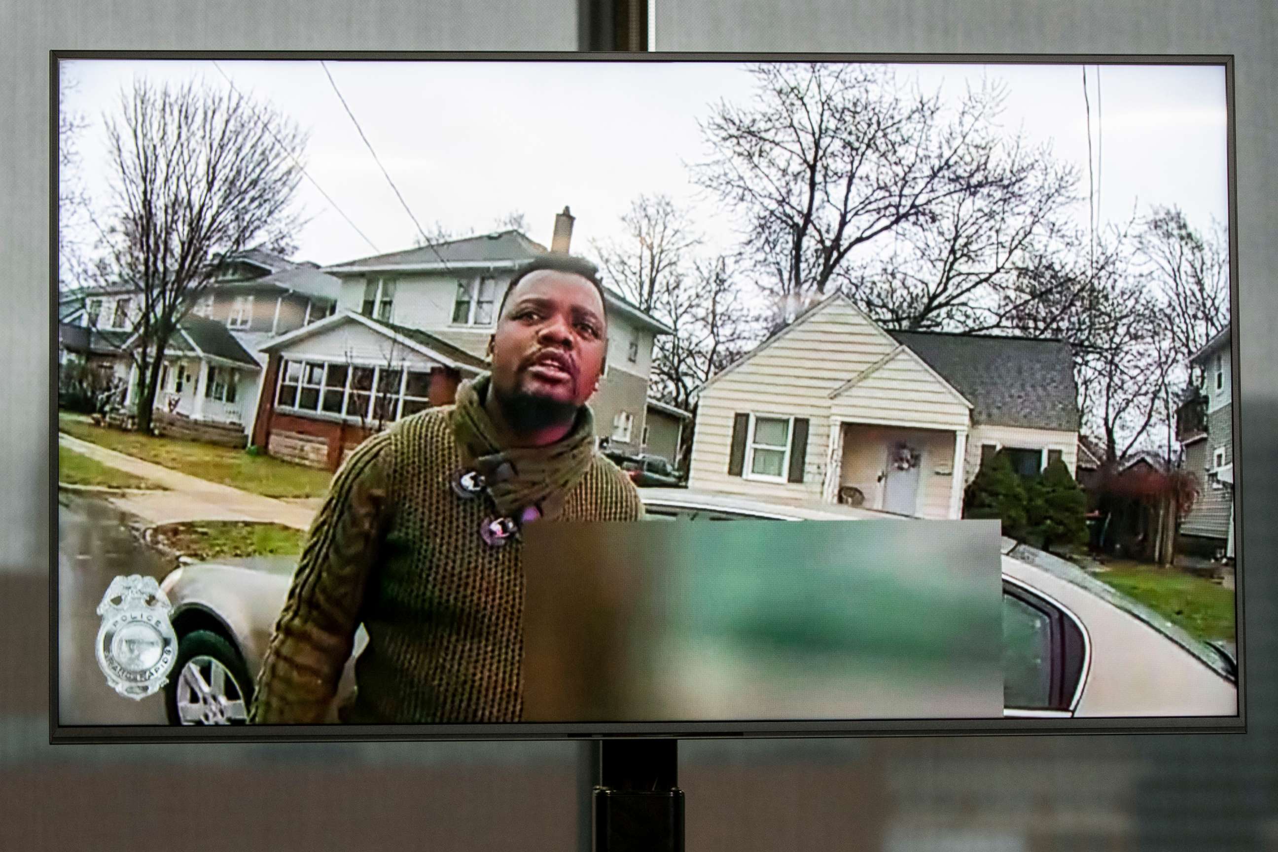 PHOTO: A monitor displays an image of Patrick Lyoya from police bodycam video during an encounter with a Grand Rapids police officer, during a press conference on April 13, 2022, at Grand Rapids City Hall.