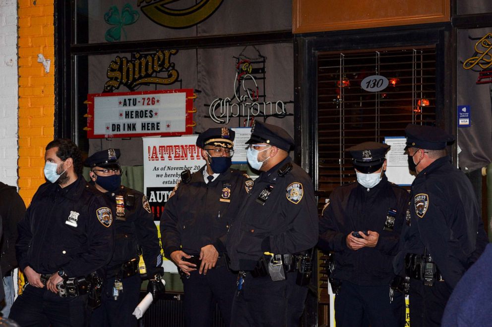PHOTO: New York City Sheriff's deputies stand outside Mac's Public House after co-owner Danny Presti was arrested in the Staten Island, New York, Dec. 1, 2020.