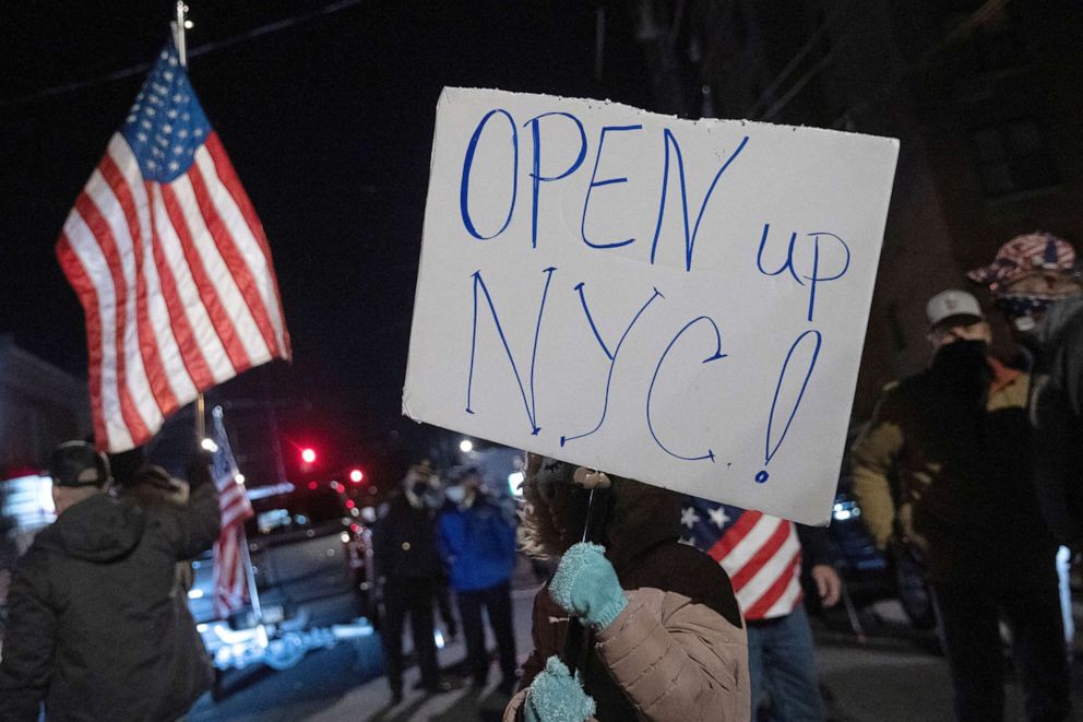 PHOTO: People protest outside of the Mac's Public House after closed it down amid the coronavirus disease (COVID-19) pandemic in Staten Island, New York, Dec. 2, 2020.