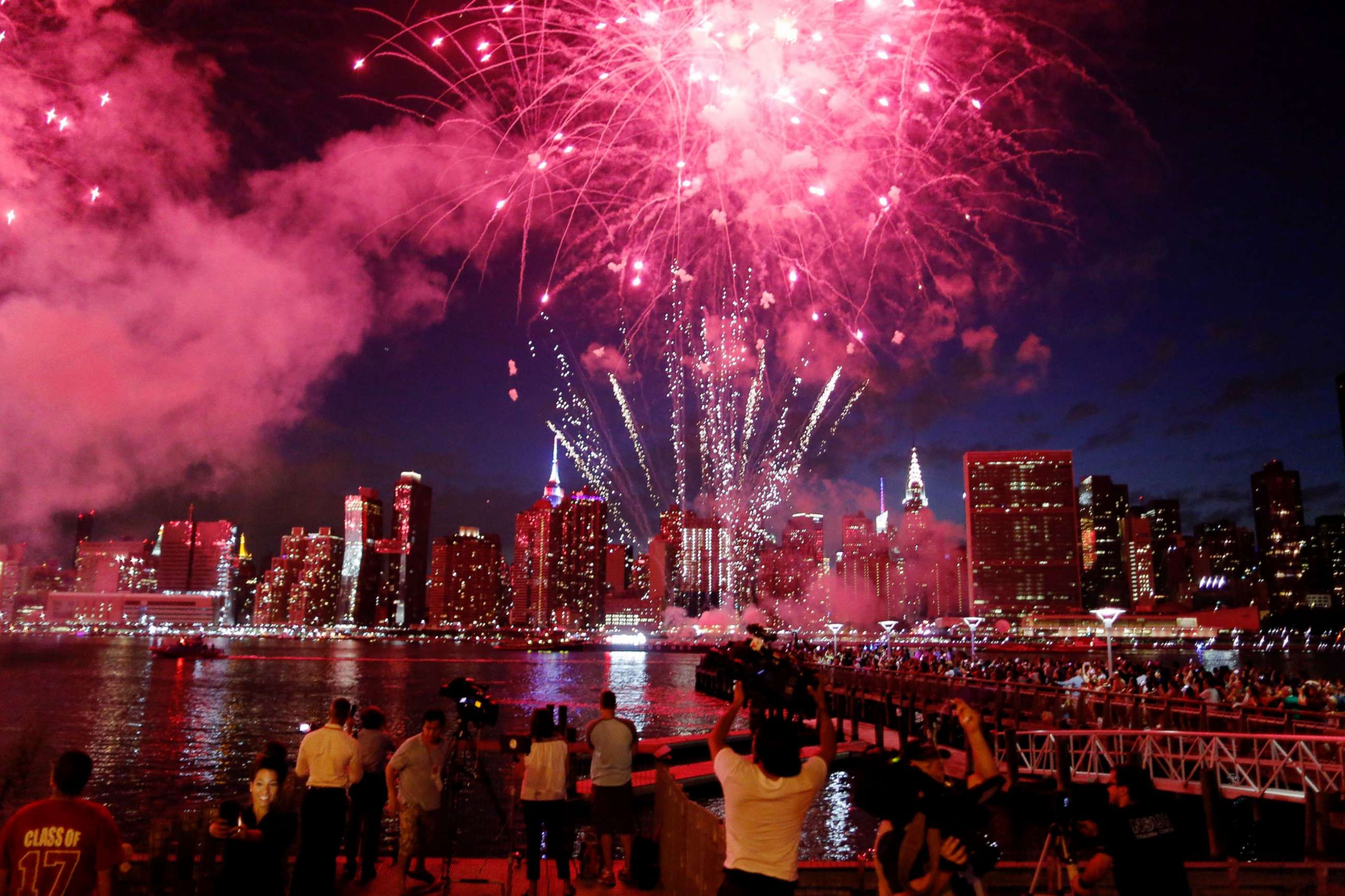 PHOTO: People watch the Macy's 4th of July fireworks show from the Queens borough of New York on July 4, 2017.