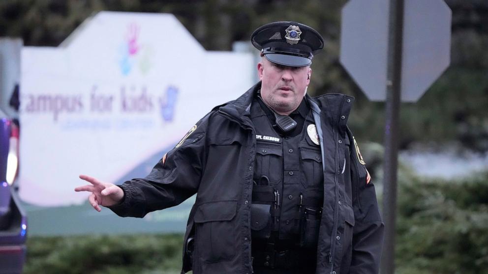 PHOTO: A police officer directs traffic as emergency vehicles are parked outside the Abundant Life Christian School in Madison, Wis., where multiple injuries were reported following a shooting, Dec. 16, 2024. 