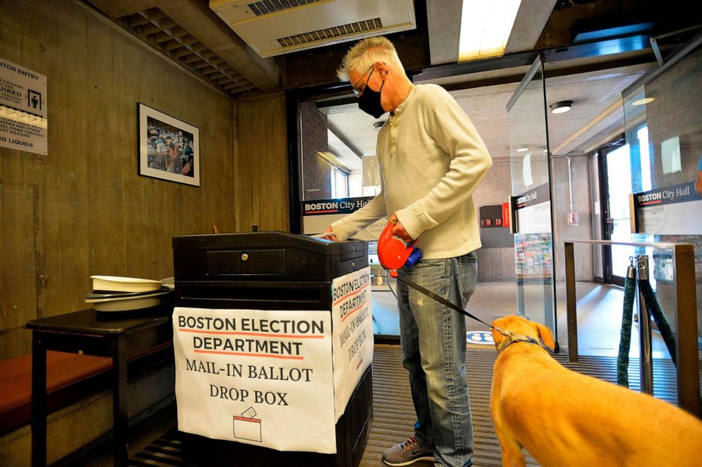 PHOTO: A man with his dog drops off his mail-in ballot at Boston City Hall during the Massachusetts State Primary on Sept. 1, 2020, in Boston.