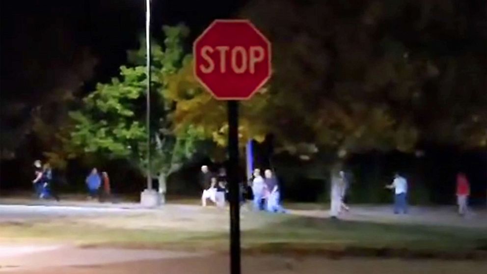 PHOTO: People run from the Sparetime bowling alley during a shooting in Lewiston, ME., Oct. 25, 2023.