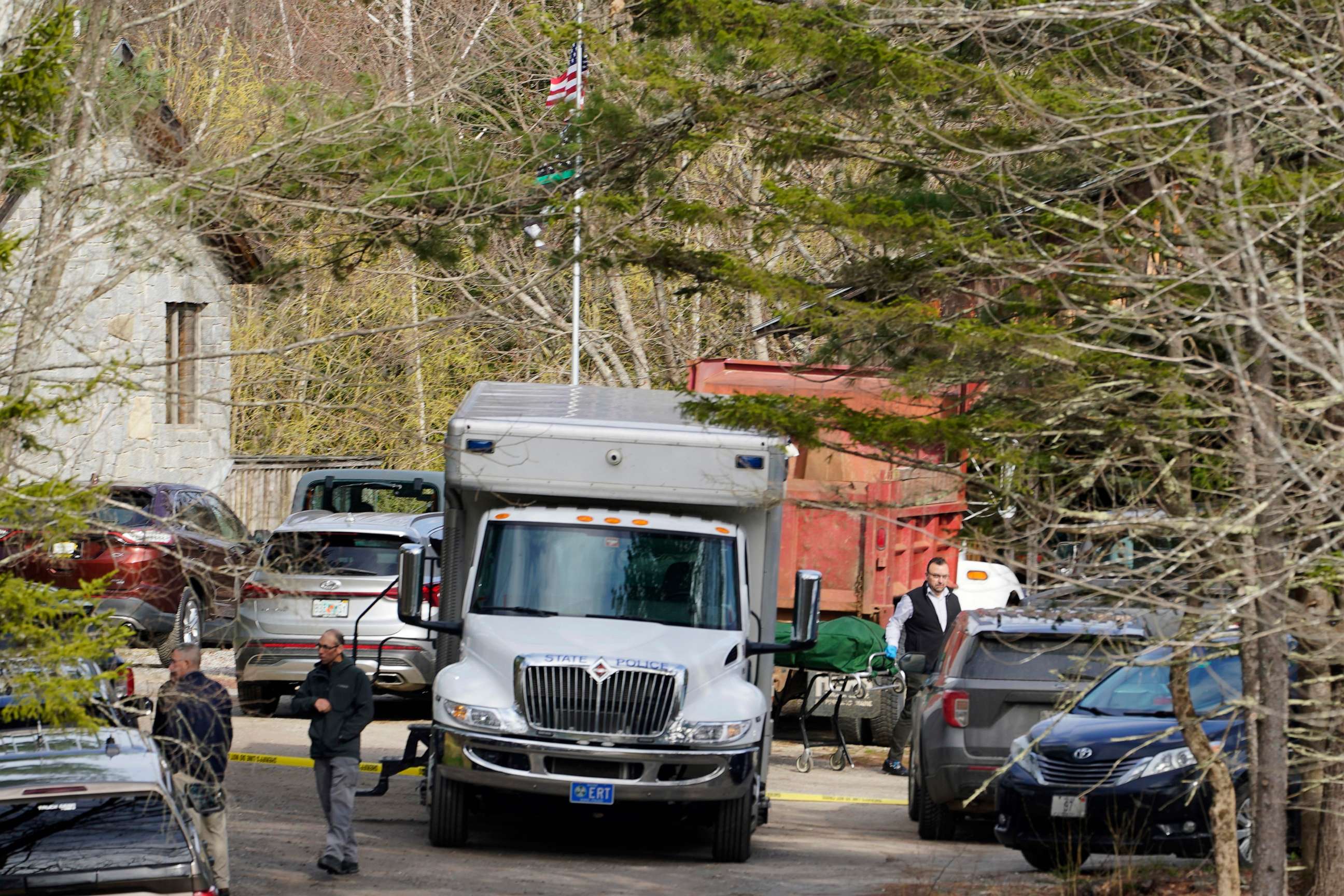 PHOTO: A body is wheeled to a hearse at the scene of a shooting, April 18, 2023, in Bowdoin, Maine.
