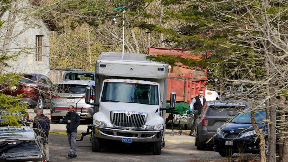 PHOTO: A body is carried into a hearse at the scene of a shooting, April 18, 2023, in Bowdoin, Maine.