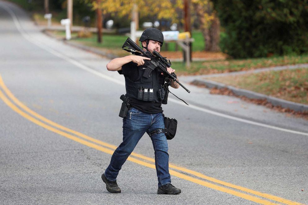 PHOTO: A member of law enforcement crosses a road, following a deadly mass shooting in Lewiston, in Lisbon Falls, Maine, Oct. 26, 2023.