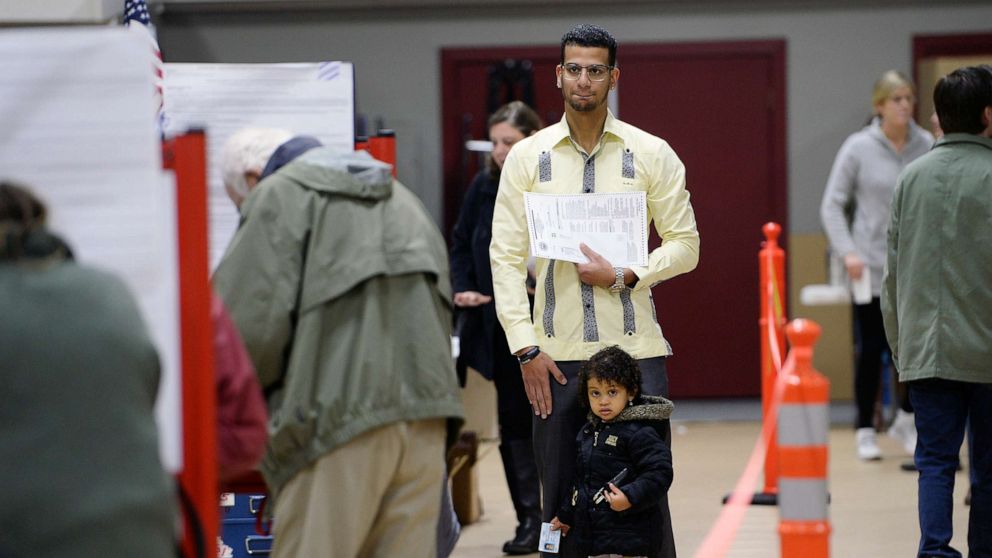 PHOTO: Luis Sanchez waits for a booth to open up as he votes with his daughter Sophia 2, at the Saco Community Center, Nov. 6, 2018, in Saco, Maine.