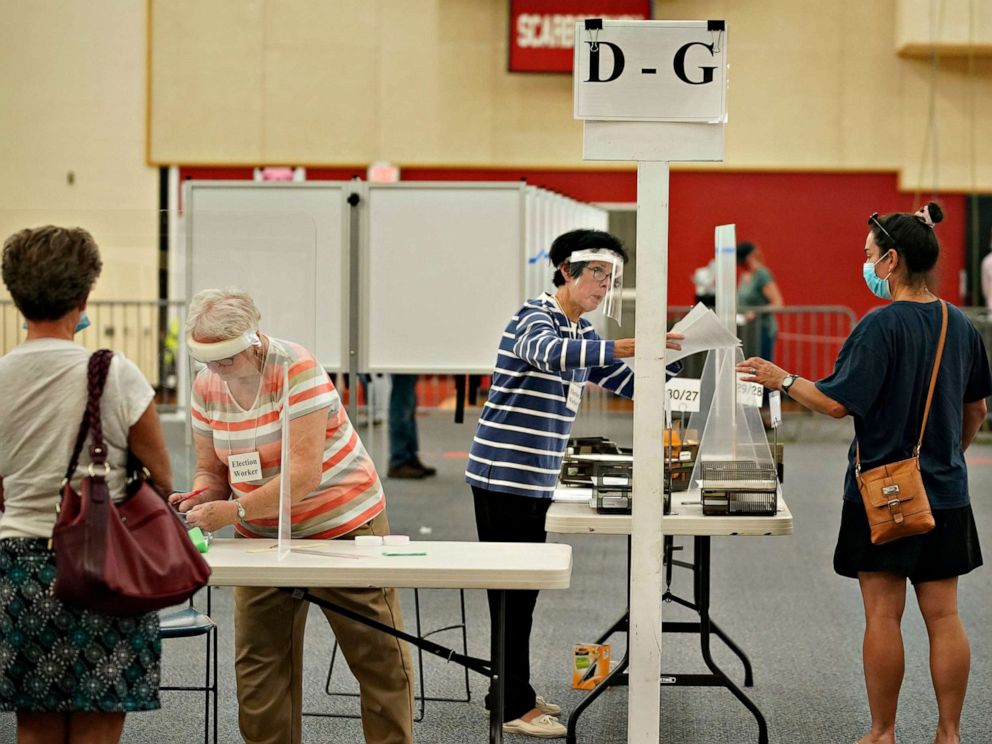 PHOTO: Election workers assist voters at Scarborough High School, July 14, 2020, in Scarborough, Maine.