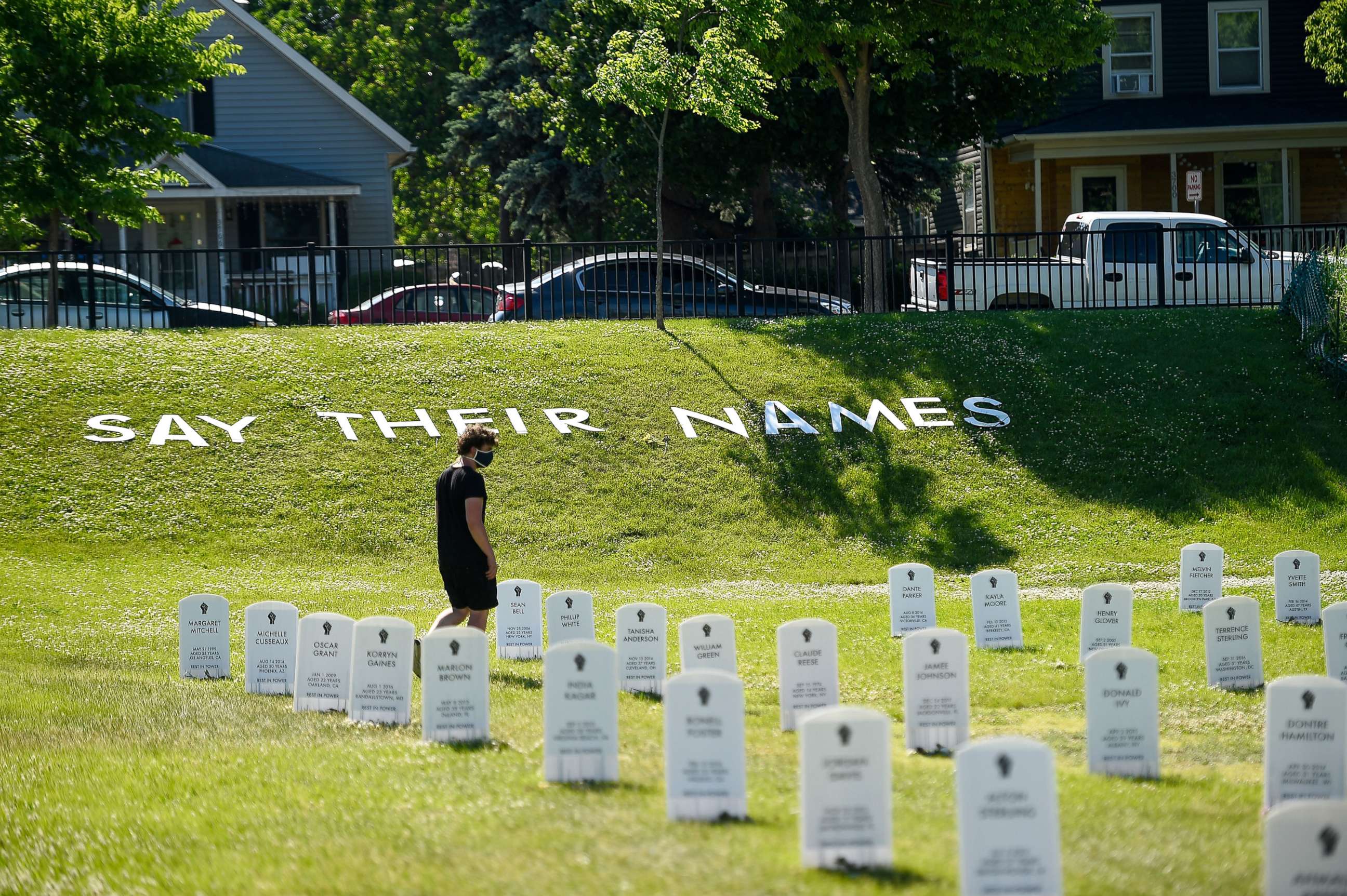 PHOTO: A man walks through a make shift cemetery near the intersection of 38th and Chicago in front of the Cup Foods, June 8, 2020.