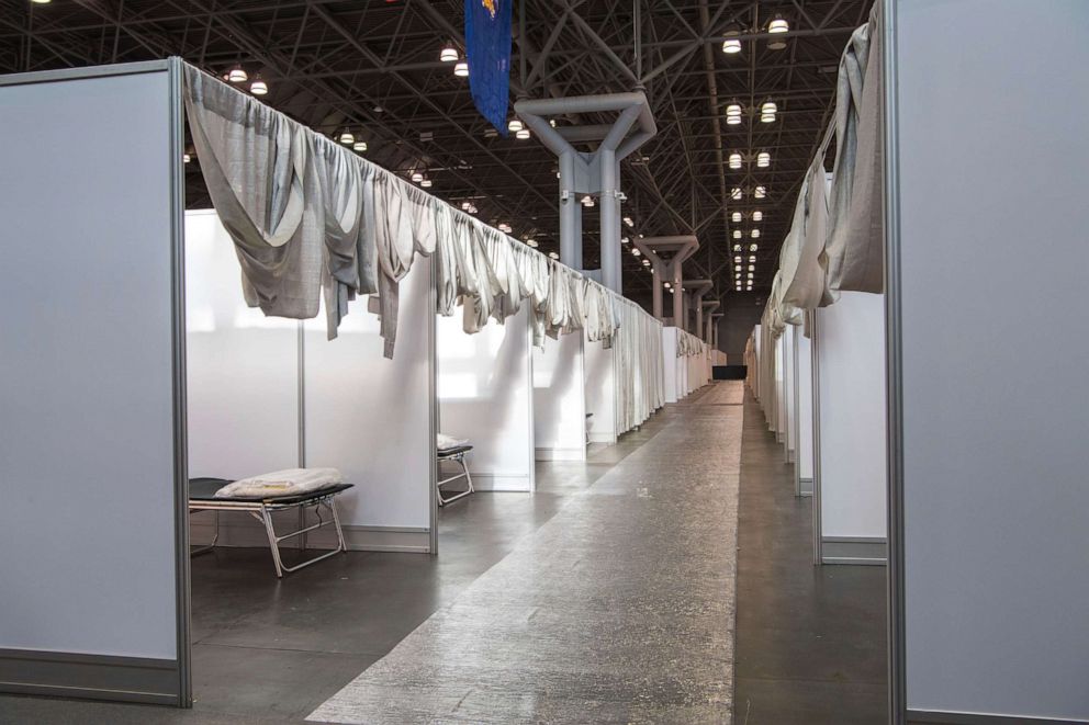 PHOTO: In this photo provided by the office of New York Gov. Andrew Cuomo on March 27, 2020, makeshift hospital rooms stretch out along the floor at the Jacob K. Javits Convention Center in New York City.