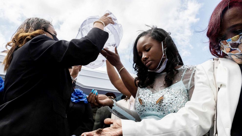 PHOTO: Ja'Niah Bryant releases butterflies into the air during funeral of her sister Ma'Khia Bryant in Columbus, Ohio, April 30, 2021.