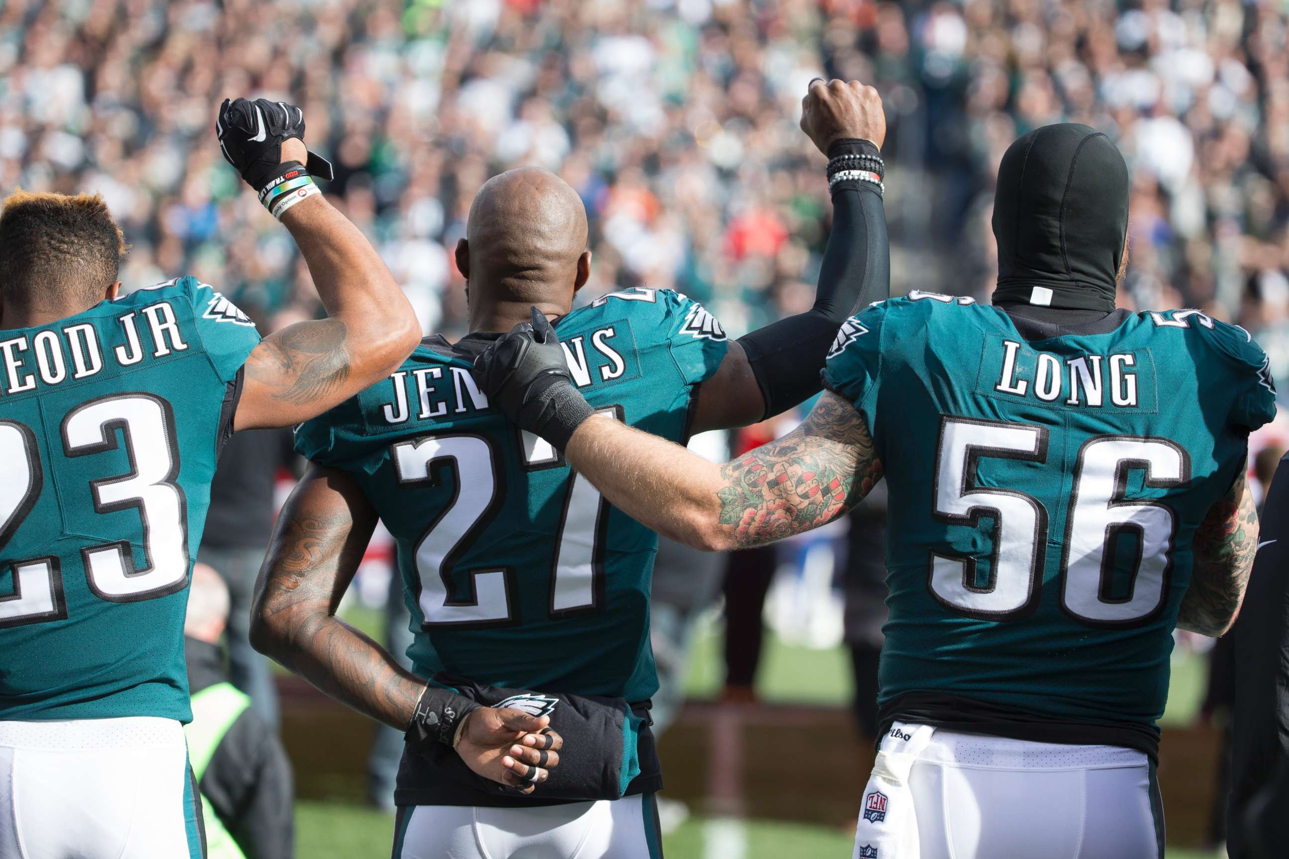 PHOTO: Rodney McLeod and Malcolm Jenkins of the Philadelphia Eagles raise their fists as teammate Chris Long #56 stands alongside them during the national anthem prior to the game against the Chicago Bears at Lincoln Financial Field on Nov. 26, 2017.