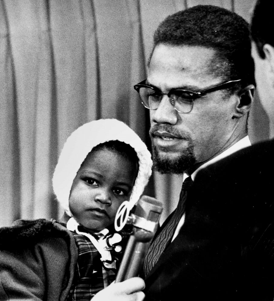 PHOTO: Black leader Malcolm X with his daughter Ilyasah at Kennedy airport in New York, Nov. 24, 1964
