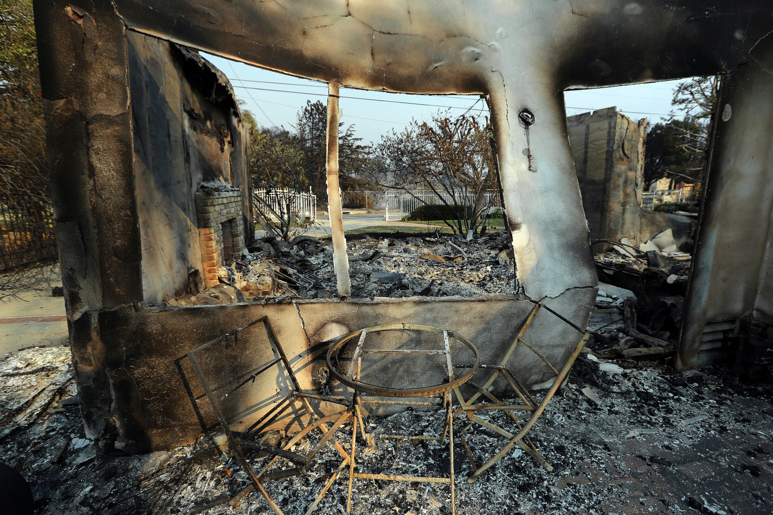 PHOTO: A table and chairs stand outside of one of at least 20 homes destroyed just on Windermere Drive in the Point Dume area of Malibu, Calif., Saturday, Nov. 10, 2018. Known as the Woolsey Fire, it has consumed thousands of acres and dozens of homes.