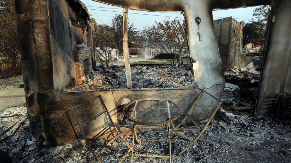 PHOTO: A table and chairs stand outside of one of at least 20 homes destroyed just on Windermere Drive in the Point Dume area of Malibu, Calif., Saturday, Nov. 10, 2018. Known as the Woolsey Fire, it has consumed thousands of acres and dozens of homes.