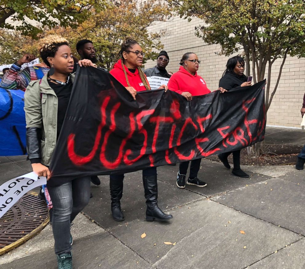 PHOTO: Protestors carry a sign reading "Justice for E.J." during a protest at the Riverchase Galleria in Hoover, Ala., Nov. 24, 2018.
