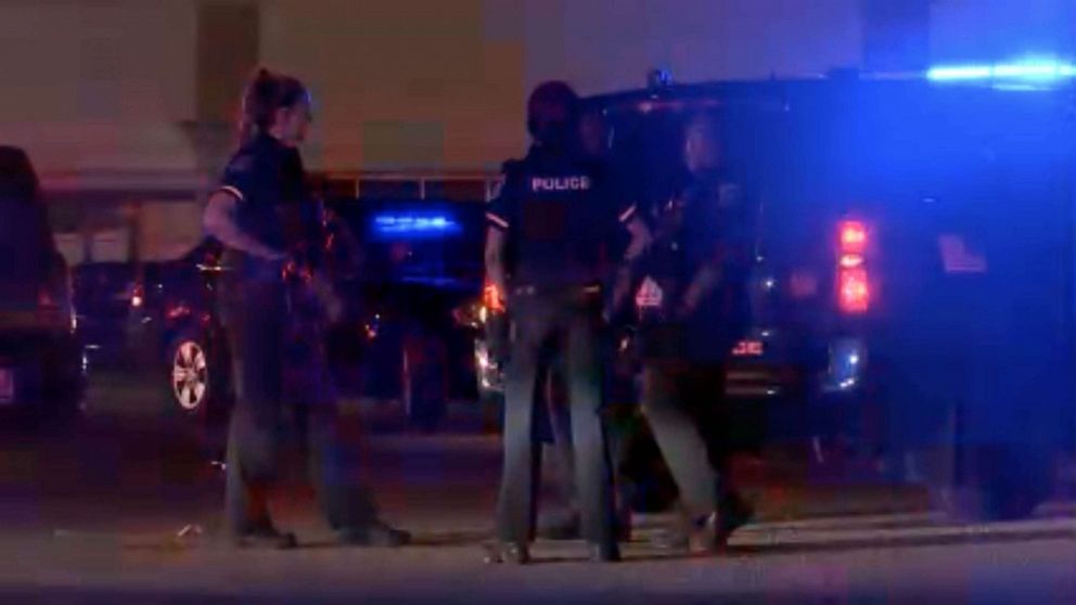 PHOTO: Police officers cordon off a crime scene at the Logan Square Mall in Lansing on July 30, 2023, after a shooting left five people injured, two in critical condition.