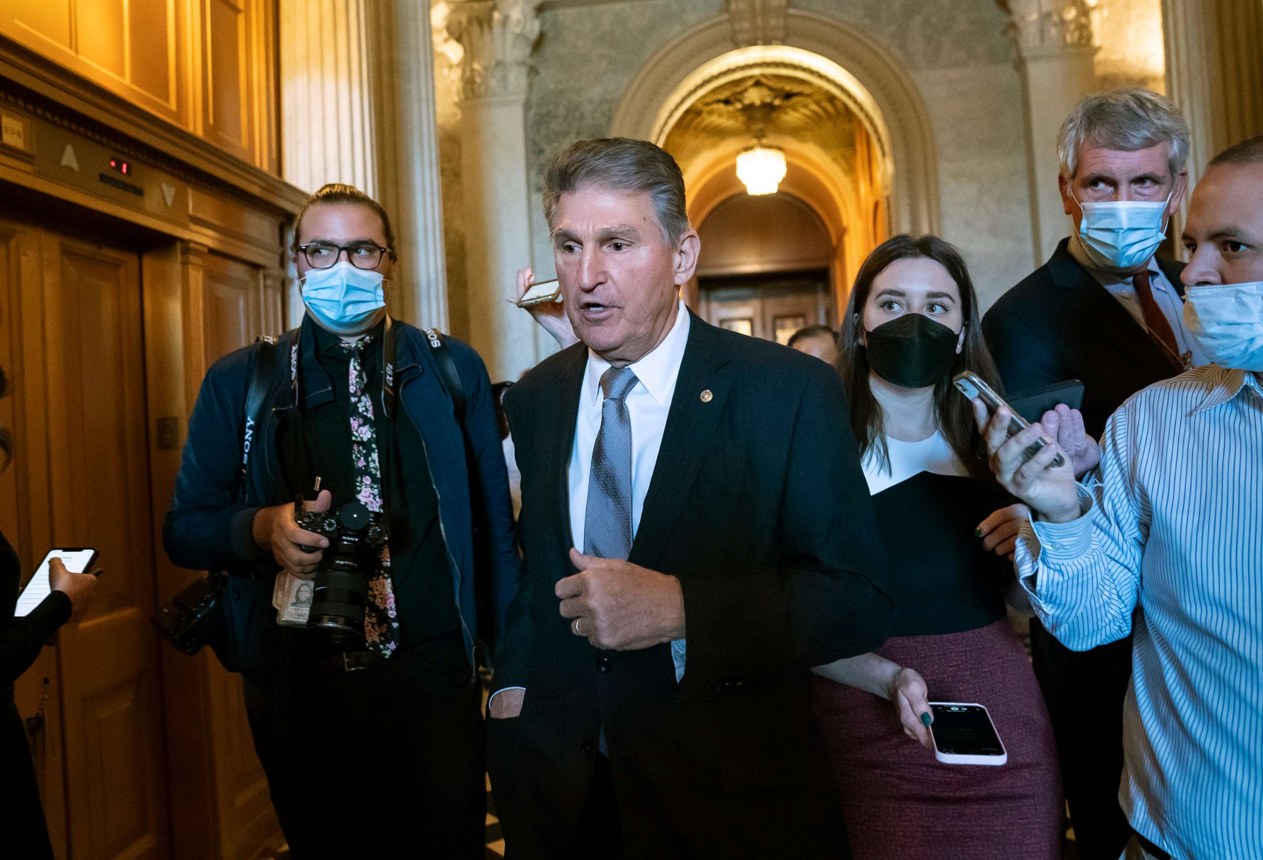 PHOTO: Sen. Joe Manchin, who has been a key holdout on President Joe Biden's ambitious domestic package, is surrounded by reporters as he leaves the chamber after a vote, at the Capitol in Washington, D.C., Nov. 3, 2021.