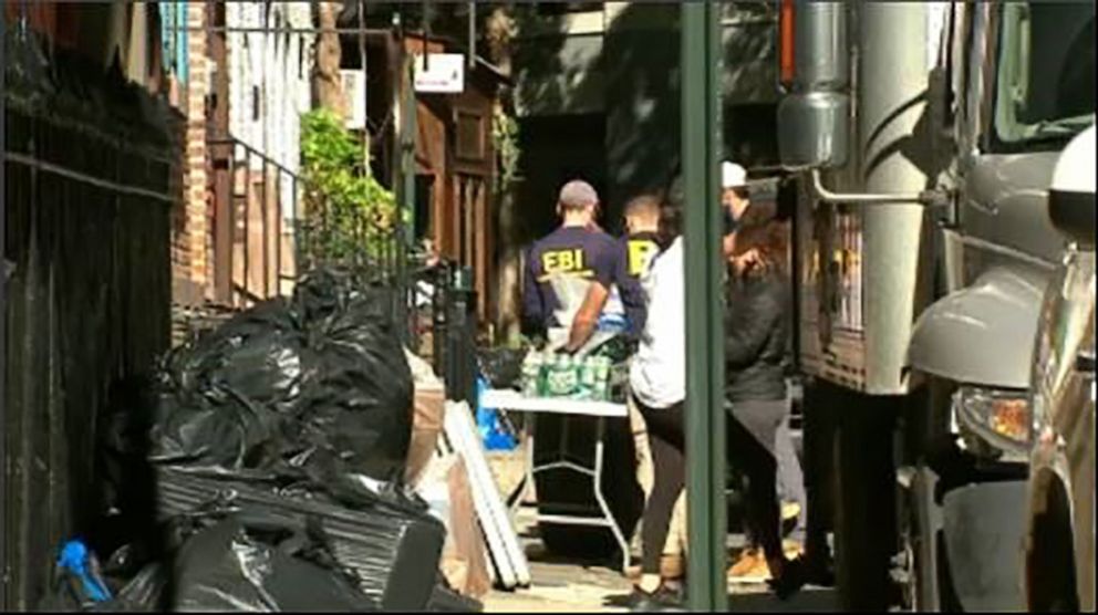 PHOTO: FBI agents in New York search a townhouse in Manhattan's West Village neighborhood, Oct. 19, 2021.