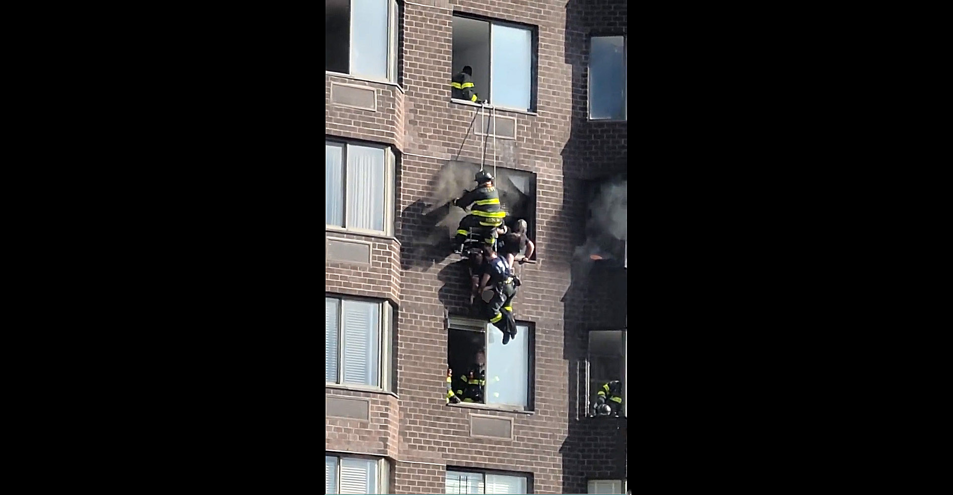 PHOTO:  A woman is rescued by NYFD firemen in an image taken from video posted to Twitter, after a fire in a Midtown Manhattan high-rise trapped residents in the morning of Nov.5, 2022, leaving several people injured, according to the FDNY.