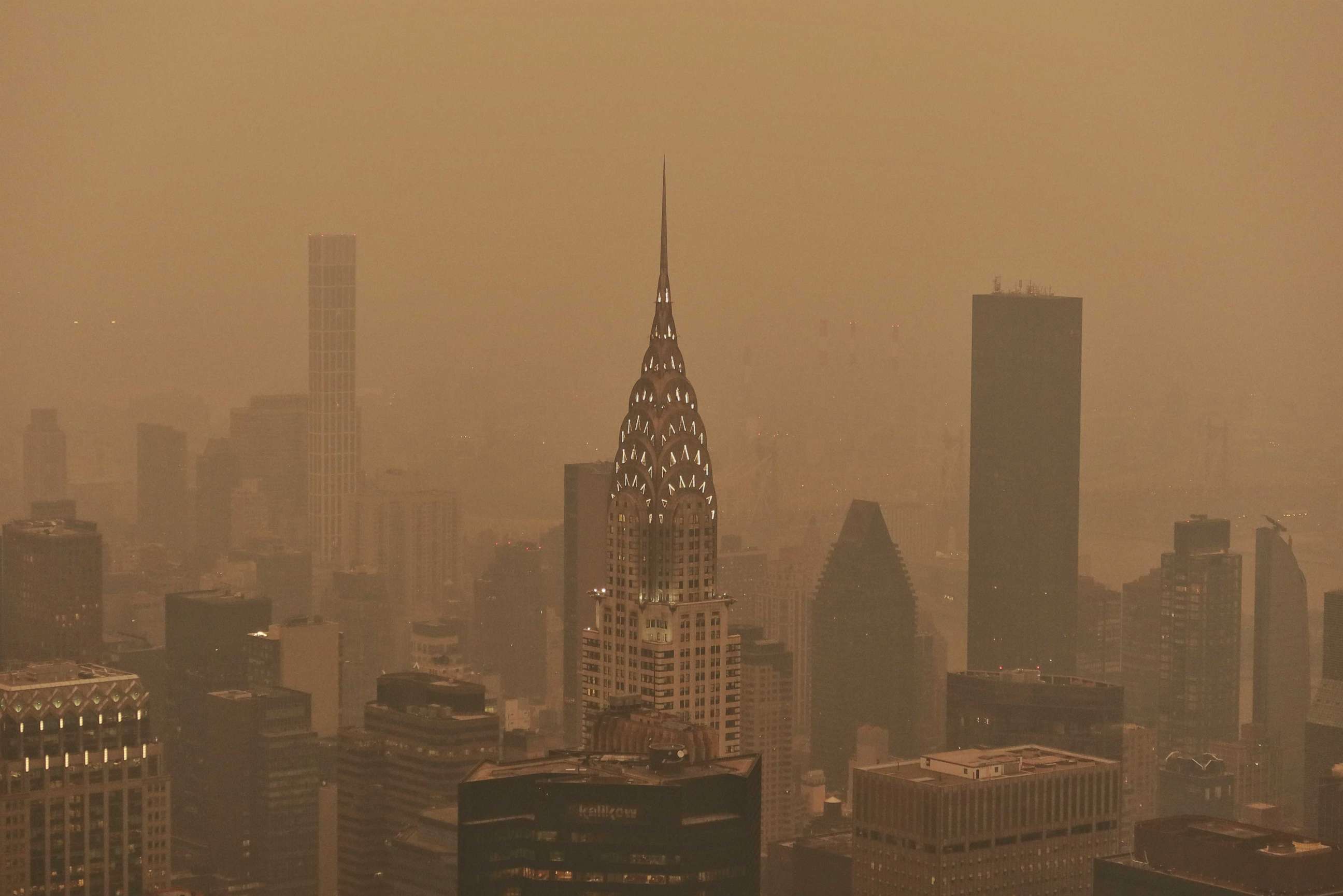 PHOTO: The Chrysler Building in Manhattan's skyline is barely visible before sunset as the city is enveloped in smoke from continued wildfires in Canada on June 6, 2023, New York City.