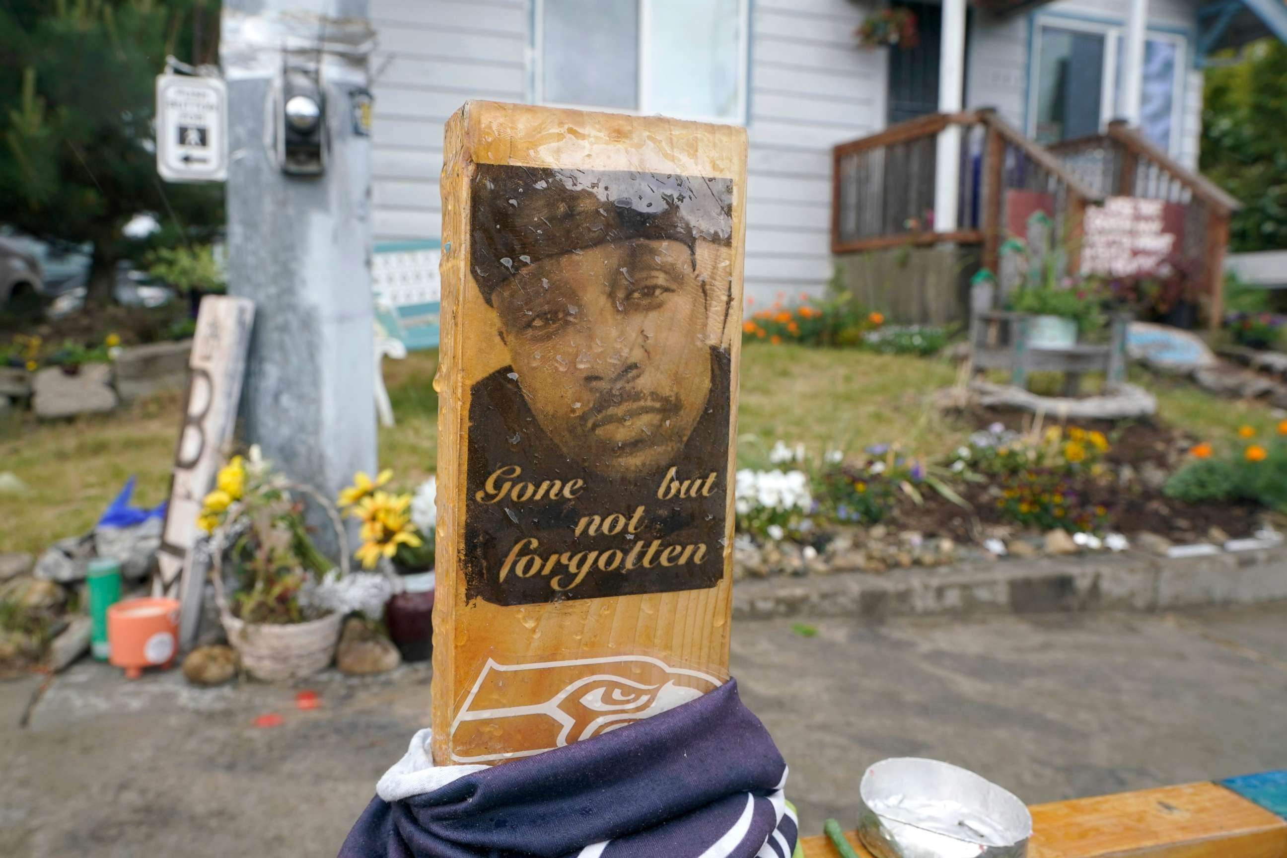 PHOTO: A sign that reads "gone but not forgotten" is shown on a cross displayed at a makeshift memorial on May 27, 2021, at the intersection in Tacoma, Washington, where Manuel "Manny" Ellis" died after he was restrained by police on March 3, 2020.