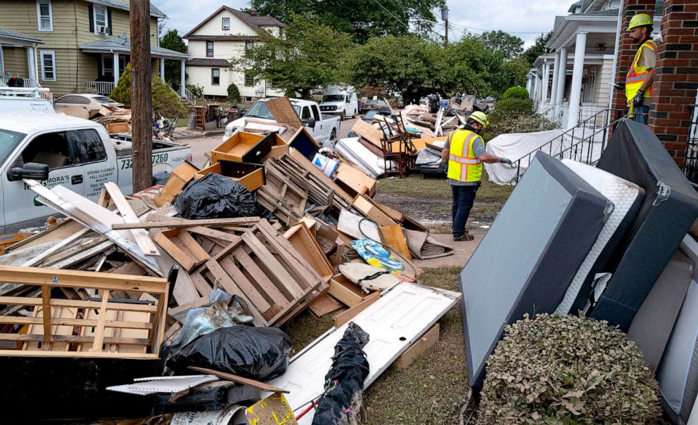 PHOTO: Utility workers work among debris from flood damage caused by the remnants of Hurricane Ida in Manville, N.J., Sept. 5, 2021. 