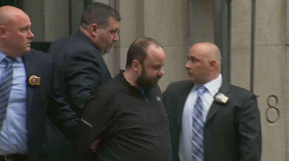 Marc Lamparello is led out of the Midtown North Precinct in Manhattan, N.Y., on Friday, April 18, 2019, after his arrest for allegedly bringing gas cans and lighter fluid to St. Patrick's Cathedral.