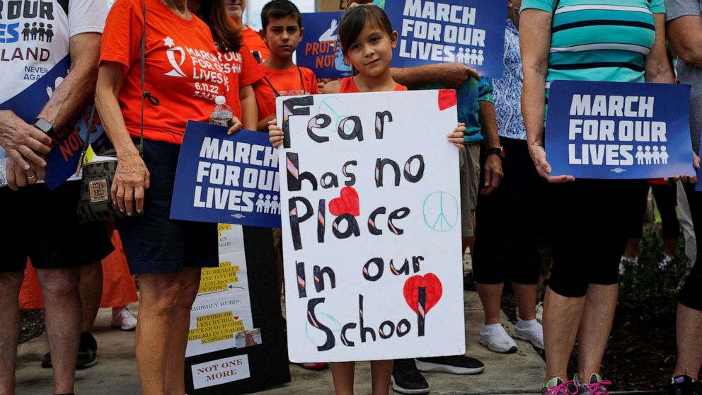 PHOTO: A girl holds a placard during a "March for our lives" rally for gun control in Parkland, Fla., June 11, 2022. 