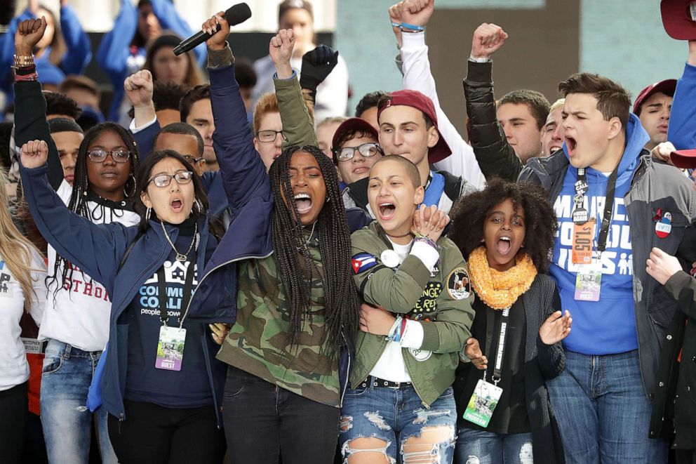 PHOTO: Students from Marjory Stoneman Douglas High School, including Emma Gonzalez, center, stand together on stage with other young victims of gun violence at the conclusion of the March for Our Lives rally on March 24, 2018, in Washington.