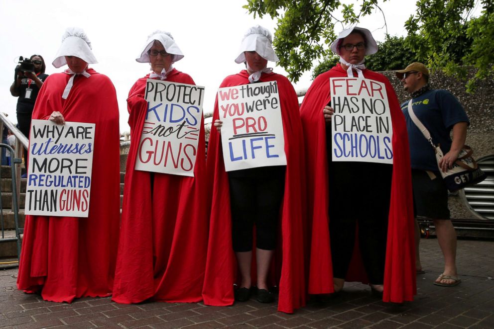 PHOTO: Activists wear red robes and white bonnets based on "The Handmaid's Tale" before the March for Our Lives in downtown Houston, March 24, 2018.