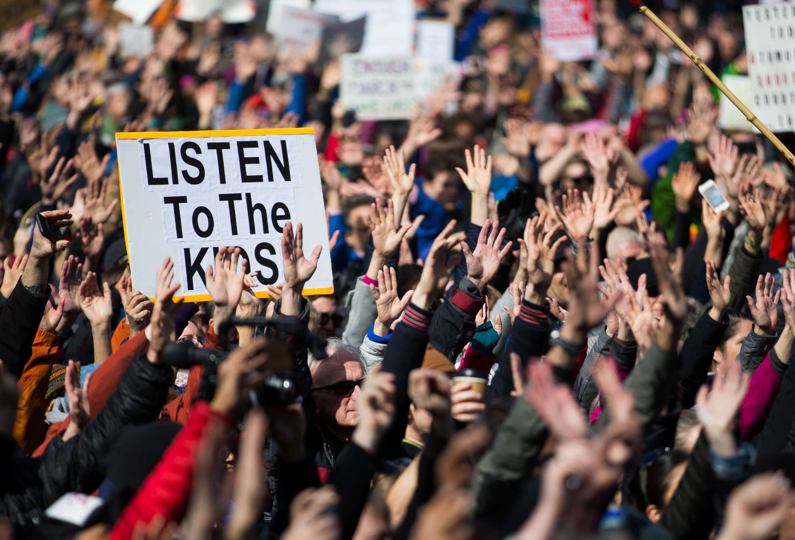 PHOTO: People hold their hands up as directed by musician Brandi Carlile at Seattle Center during the March for Our Lives rally, March 24, 2018 in Seattle.