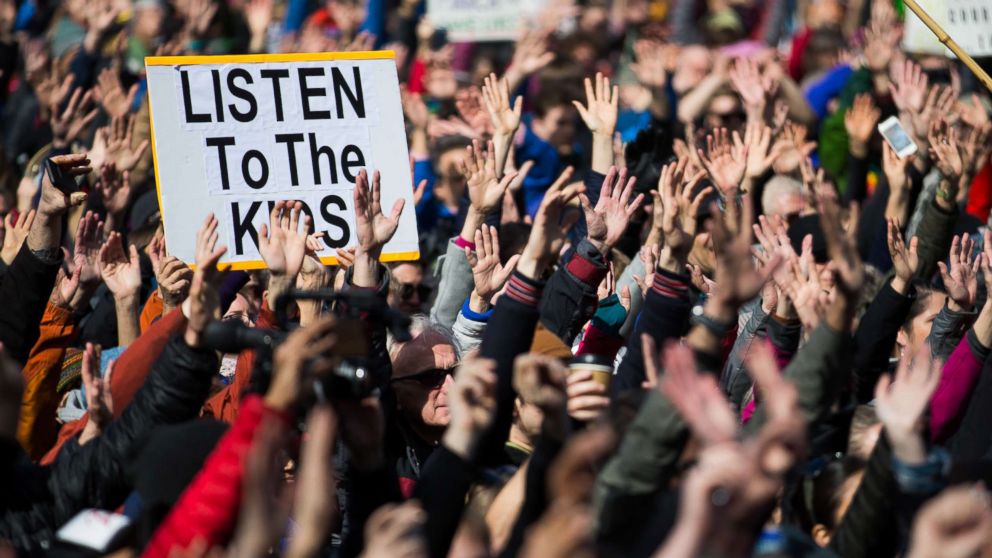 PHOTO: People hold their hands up as directed by musician Brandi Carlile at Seattle Center during the March for Our Lives rally, March 24, 2018 in Seattle.