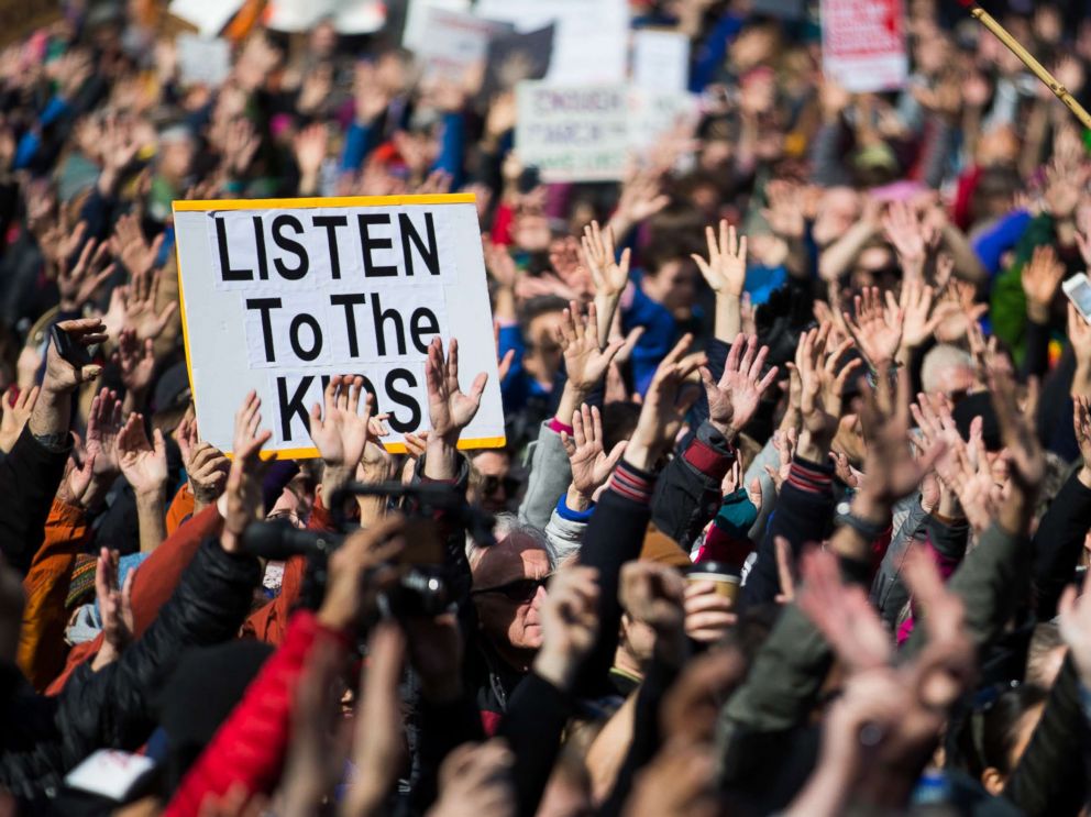 PHOTO: People hold their hands up as directed by musician Brandi Carlile at Seattle Center during the March for Our Lives rally, March 24, 2018 in Seattle.