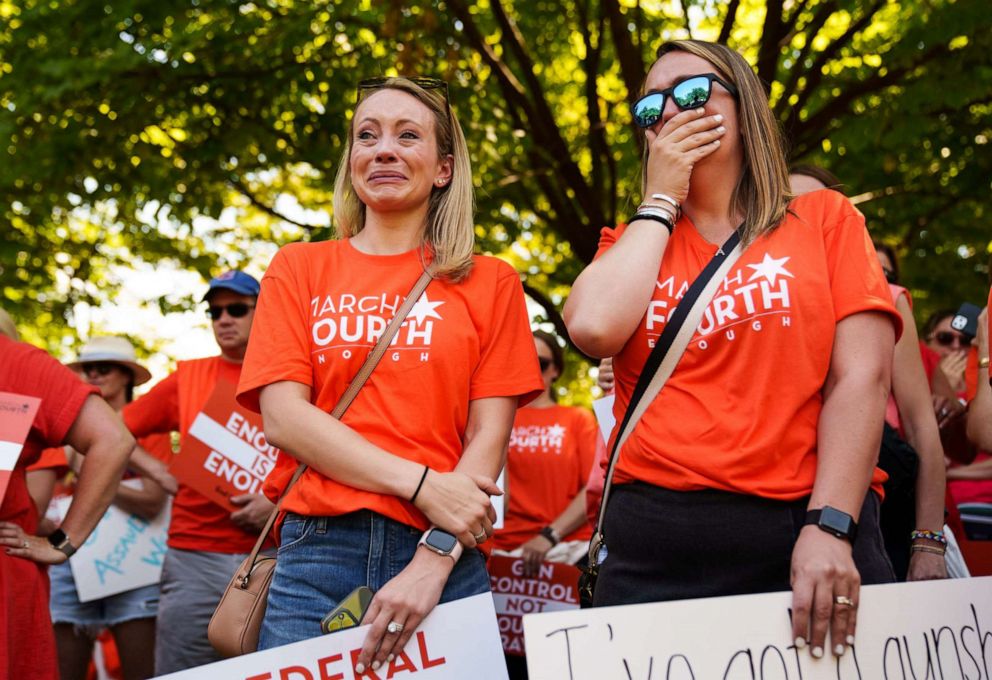 PHOTO: Abby Brosio, left, and Allie Burby, of Chicago, fight back tears during a rally at the U.S. Capitol, July 13, 2022 to call for stronger gun control measures including universal background checks and an assault weapons ban.
