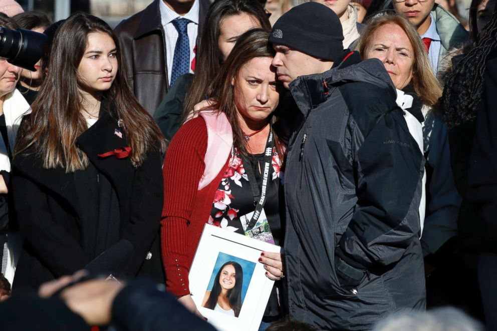 Lori Alhadeff is comforted by her husband Ilan Alhadeff as she holds a photograph of their daughter, Alyssa Alhadeff, 14, who was killed in the shootings at Marjory Stoneman Douglas High School, during a news conference on gun violence, March 23, 2018.