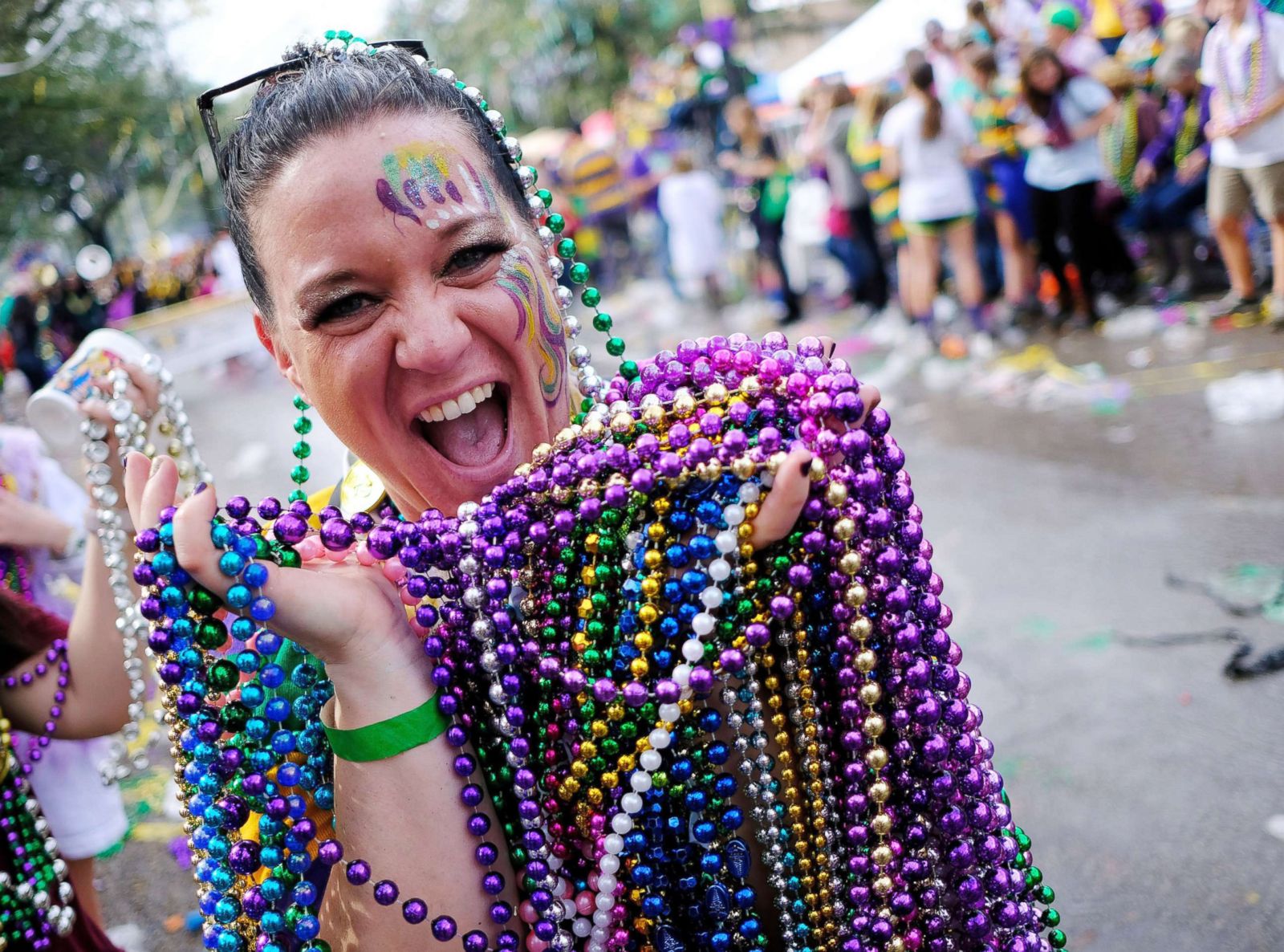 shows off her catch of beads from the Krewe of Thoth parade during Mardi Gr...