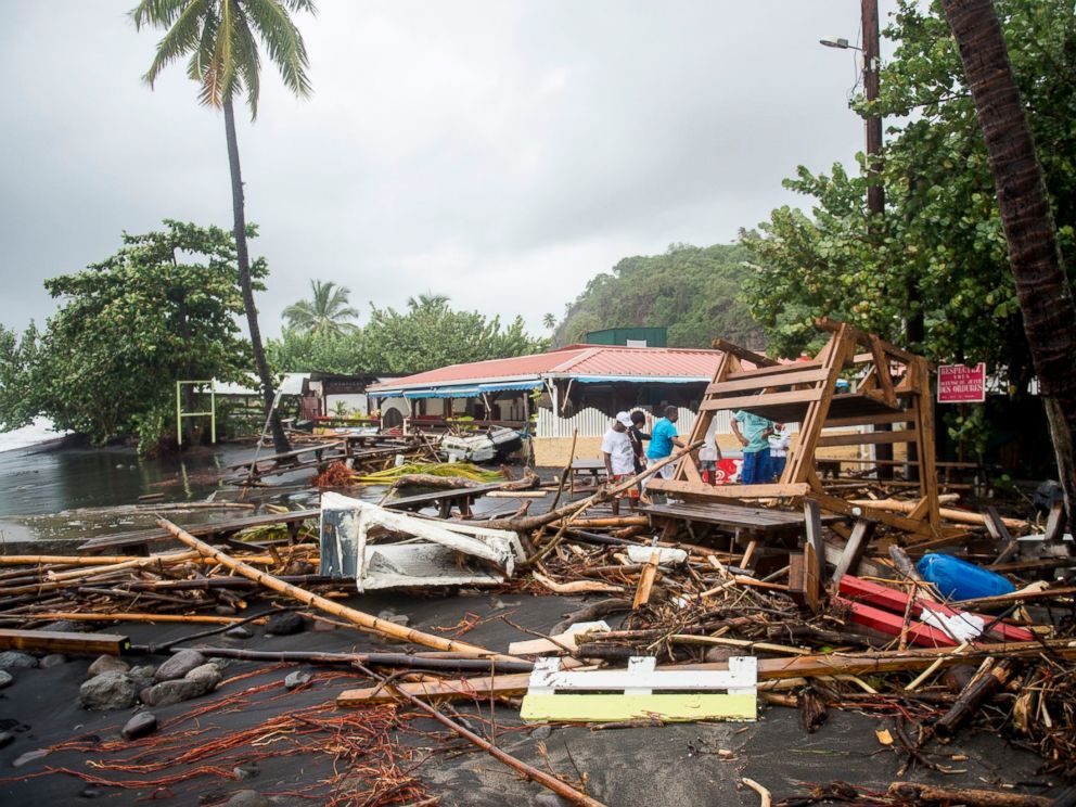 PHOTO: People stand among the debris at a restaurant in Le Carbet, on the French Caribbean island of Martinique, after it was hit by Hurricane Maria, on September 19, 2017.