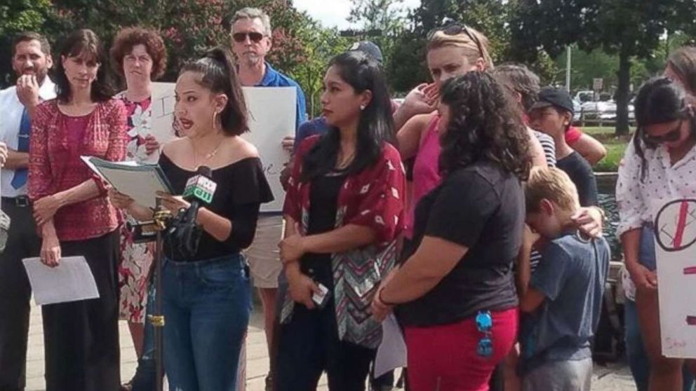 Maria (center, in red top) recounts the story of her arrest in a statement shared by Elisa Hernandez of Alerta Migratoria, an immigrants' rights group based in North Carolina.