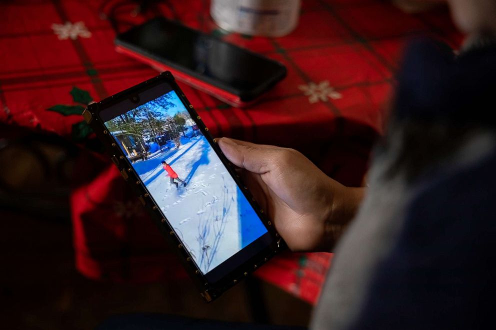 PHOTO: Maria Pineda watches a video of her son, Cristian Pavon Pineda, 11, playing in the snow for the first time, Feb. 18, 2021, in Conroe, Texas.