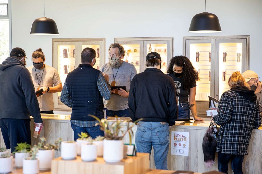 PHOTO: Employees help customers at SeaWeed Co. on the first day of recreational marijuana sales in South Portland, Maine, Oct. 9, 2020.