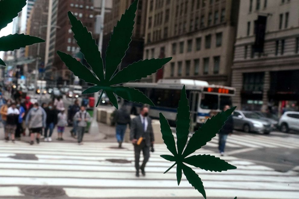 PHOTO: Cannabis stickers on a Weed World store window are pictured the day New York State legalized recreational marijuana use amid the coronavirus disease (COVID-19) pandemic in New York City, March 31, 2021.