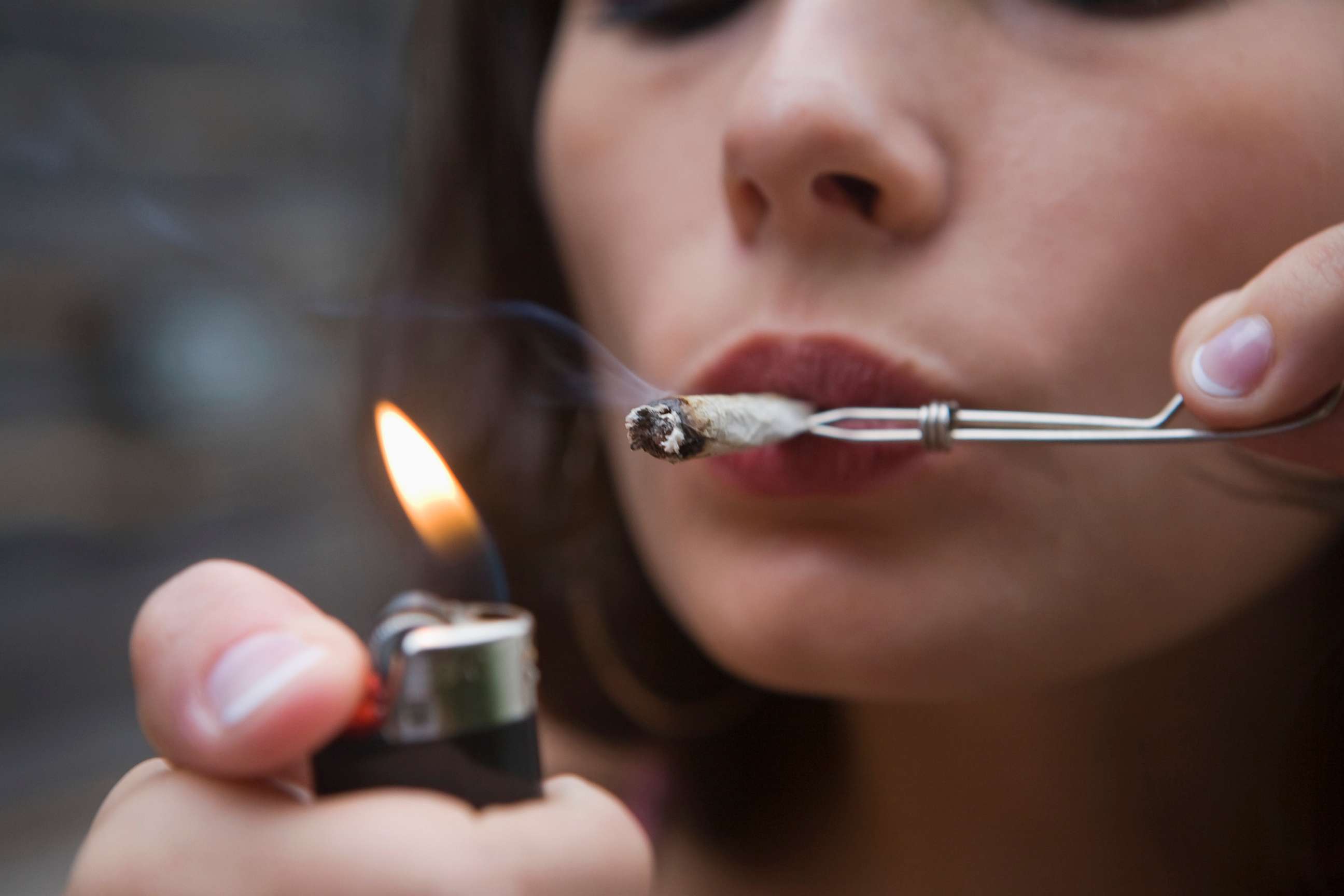 PHOTO: A woman smokes a marijuana cigarette in an undated stock photo.