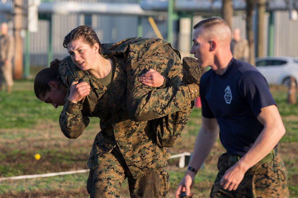 PHOTO: U.S. Marine Corps Recruit Caitlyn Doers carries a fellow recruit during maneuver under fire portion of the Combat Fitness Test at the 3rd Battalion physical training field on Marine Corps Recruit Depot, Parris Island, S.C., Feb. 15, 2018.